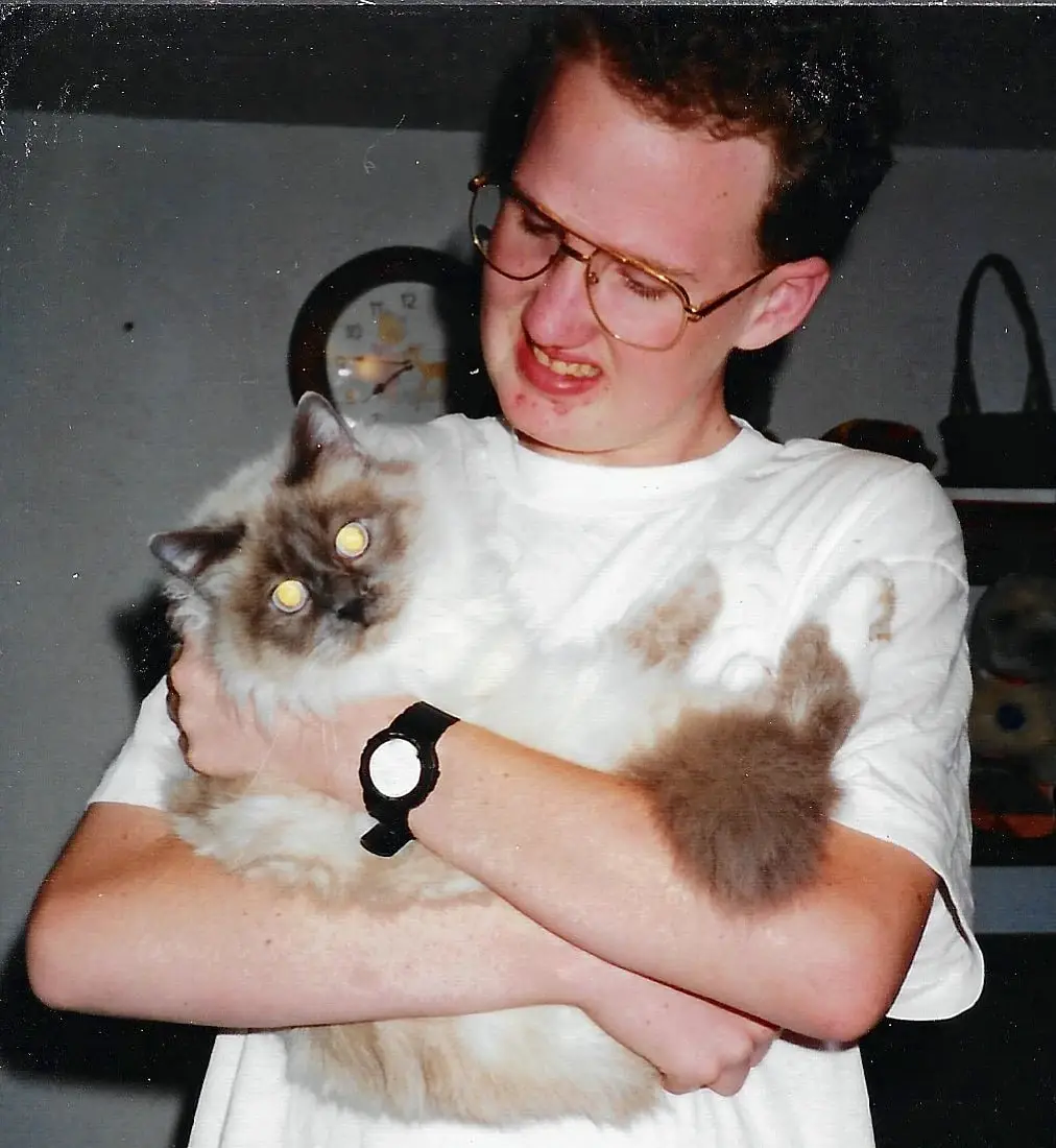 Brian, years ago, holding one of his long-haired colorpoint cats close.